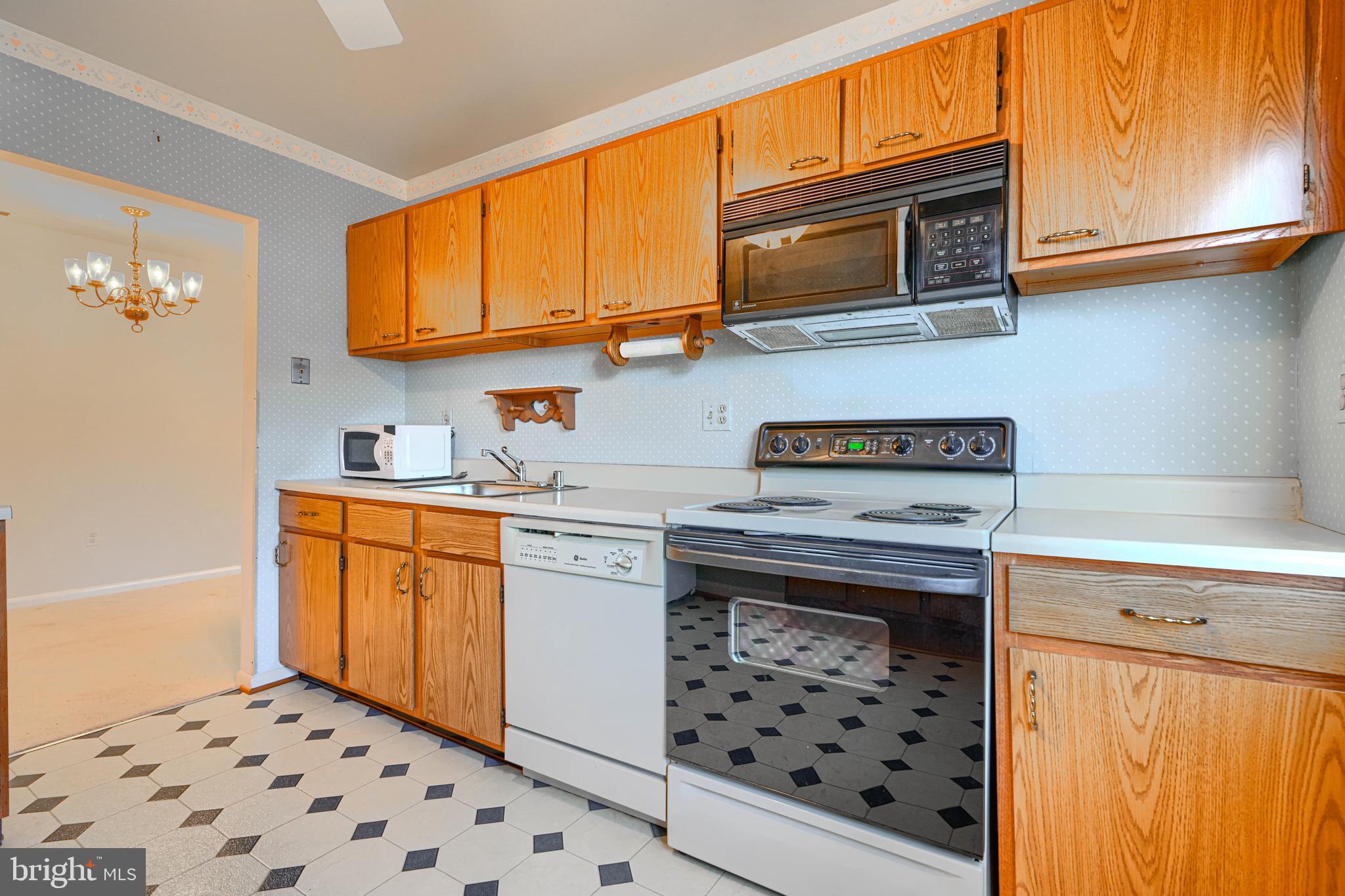 4 Juliet Lane, Unit 301 Baltimore, MD 21236 - Photo 13 of 29 a kitchen with stainless steel appliances a stove a sink and a microwave