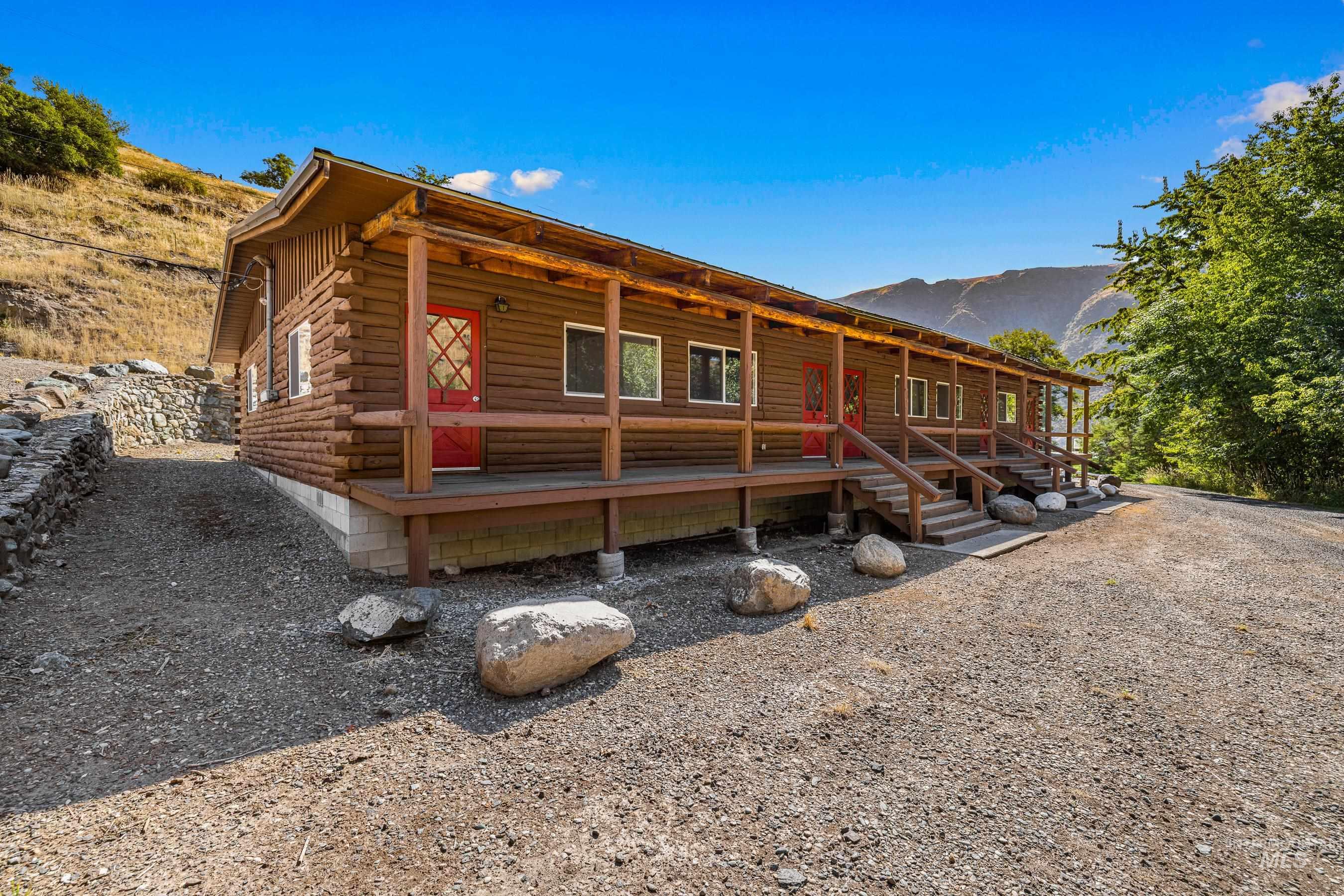 192 East Shingle Creek Road Riggins, ID 83549 - Photo 40 of 50 Log-style house featuring log exterior, a porch, and a mountain view