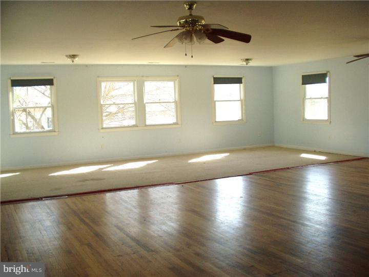 2306 Porter Road Bear, DE 19701 - Photo 4 of 9 an empty room with wooden floor and windows