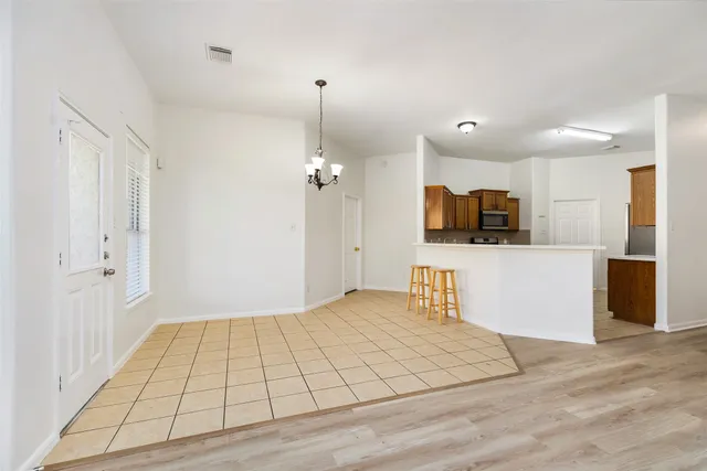 a view of a livingroom with an empty space and a window