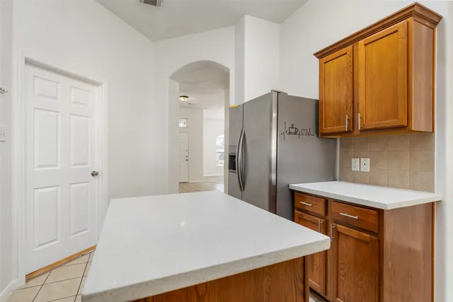 a kitchen with stainless steel appliances a refrigerator and a stove