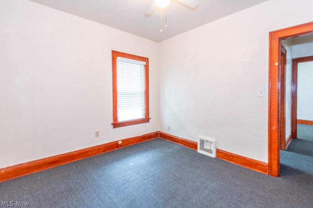917 Helmsdale Road Cleveland Heights, OH 44112 - Photo 19 of 28 Carpeted spare room with baseboards and a ceiling fan