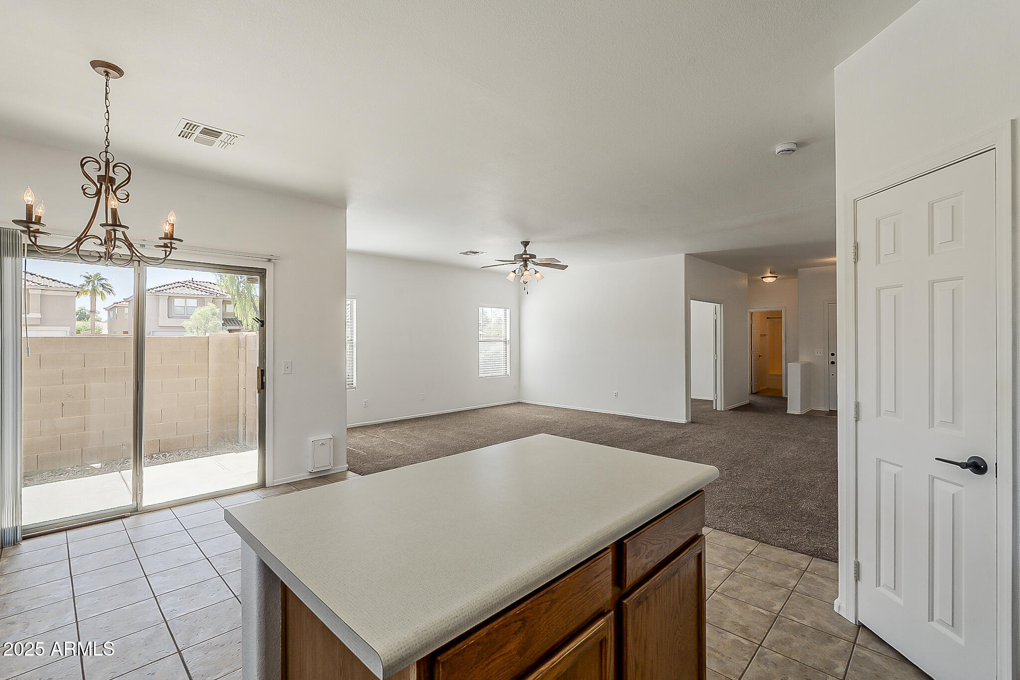 2286 East Peach Tree Drive Chandler, AZ 85249 - Photo 11 of 33 a kitchen with a table and chandelier