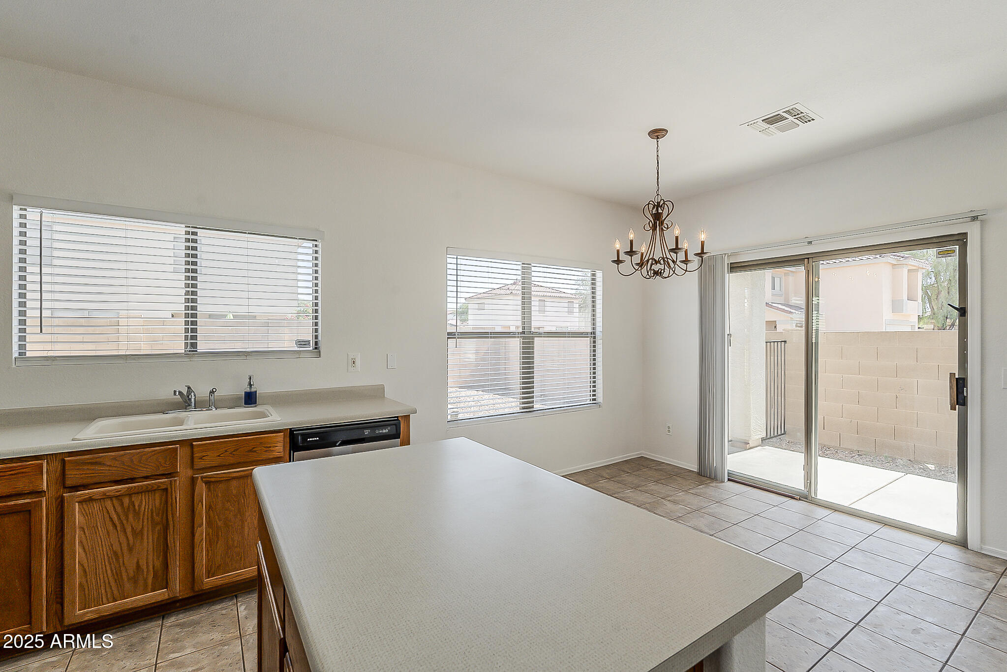 2286 East Peach Tree Drive Chandler, AZ 85249 - Photo 12 of 33 a large white kitchen with granite countertop a stove a sink and dishwasher a refrigerator with wooden floor