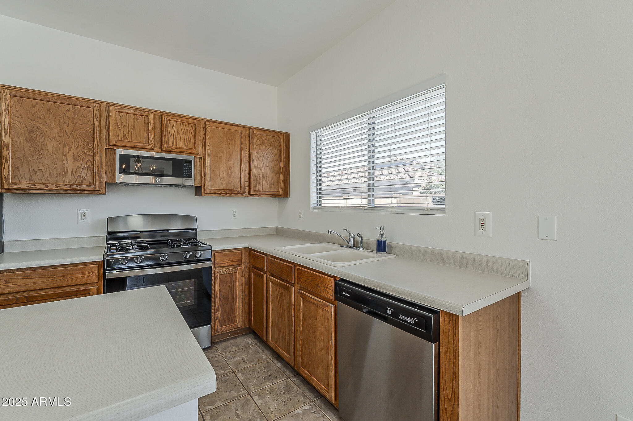 2286 East Peach Tree Drive Chandler, AZ 85249 - Photo 14 of 33 a kitchen with a sink stove and cabinets