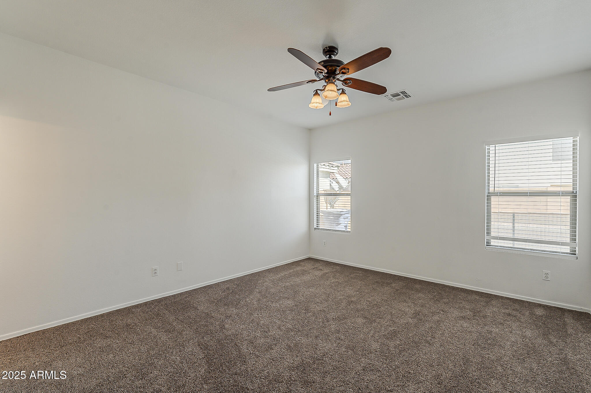 2286 East Peach Tree Drive Chandler, AZ 85249 - Photo 22 of 33 an empty room with windows and fan