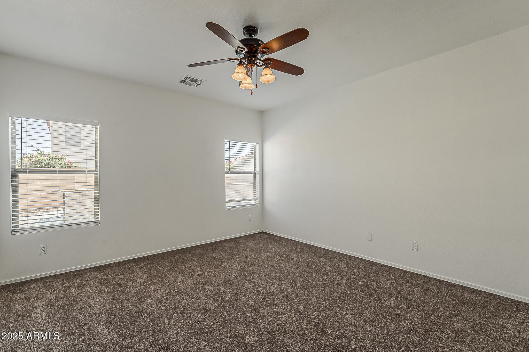 2286 East Peach Tree Drive Chandler, AZ 85249 - Photo 25 of 33 an empty room with a window and a ceiling fan