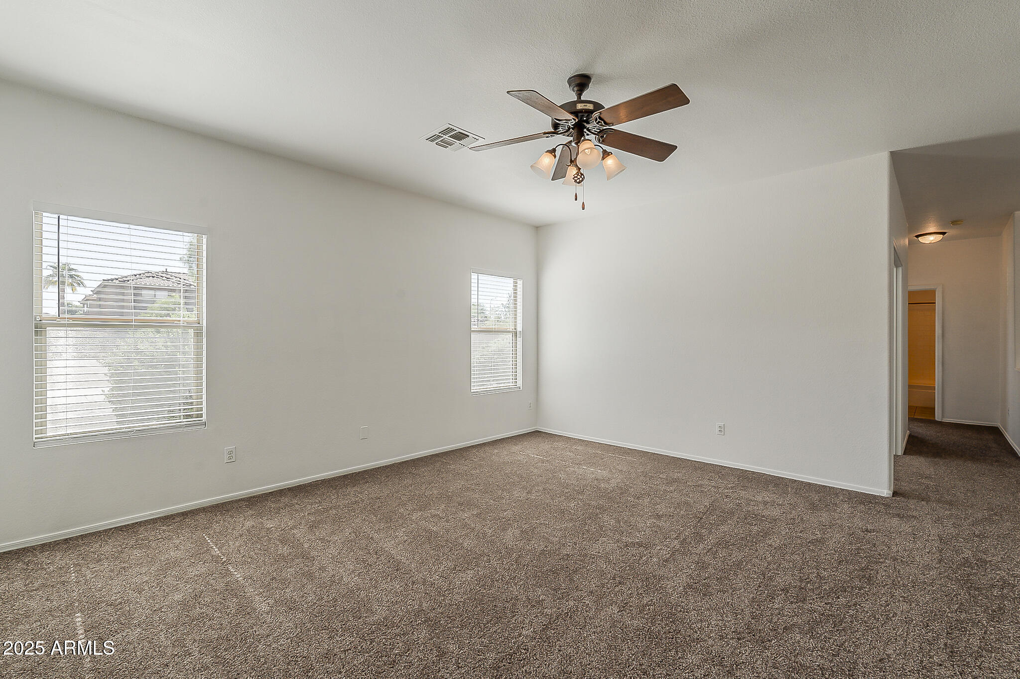 2286 East Peach Tree Drive Chandler, AZ 85249 - Photo 6 of 33 an empty room with windows and fan