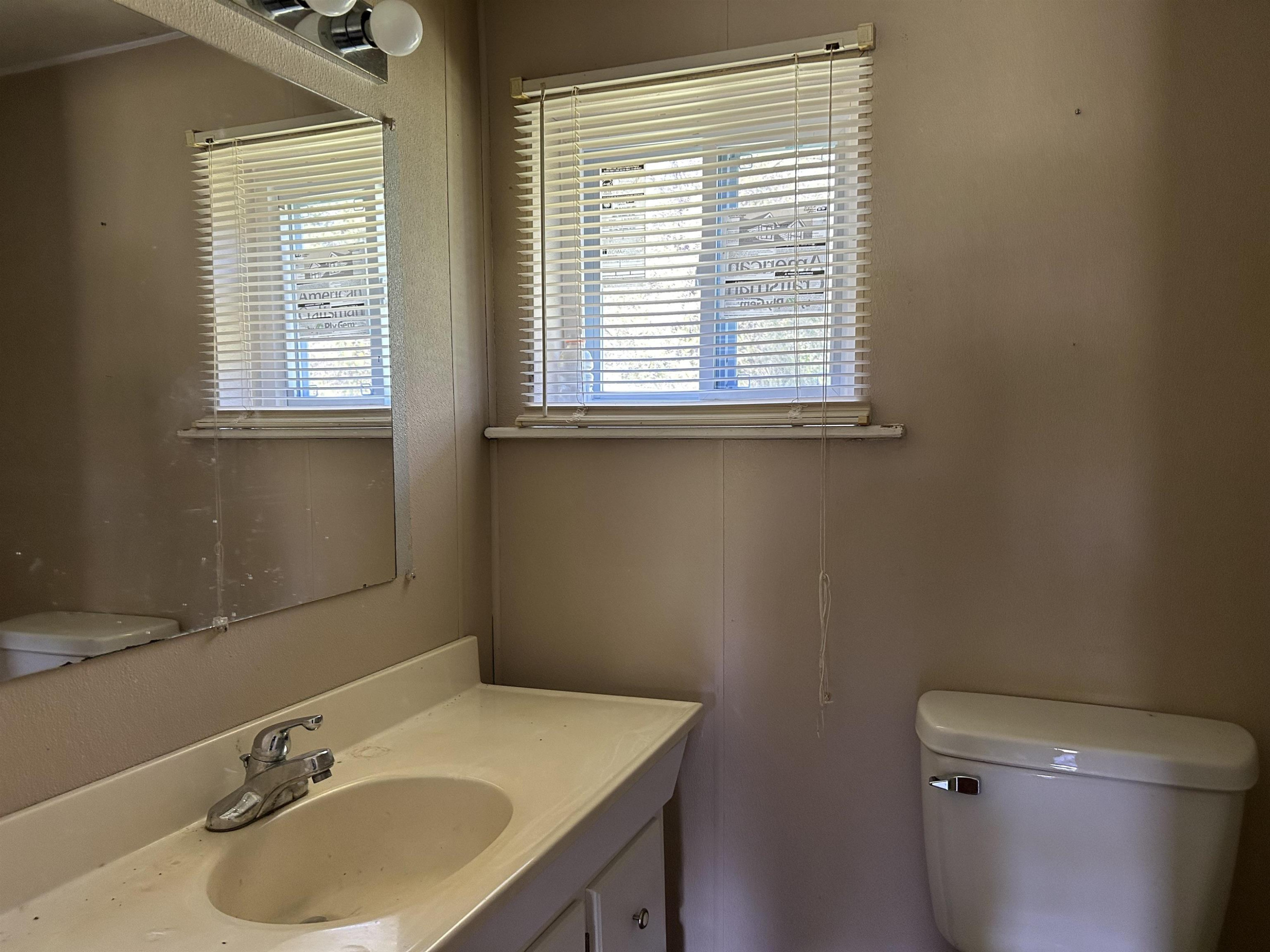 1414 Mason Road Durham, NC 27712 - Photo 14 of 16 a bathroom with a sink a toilet and a window