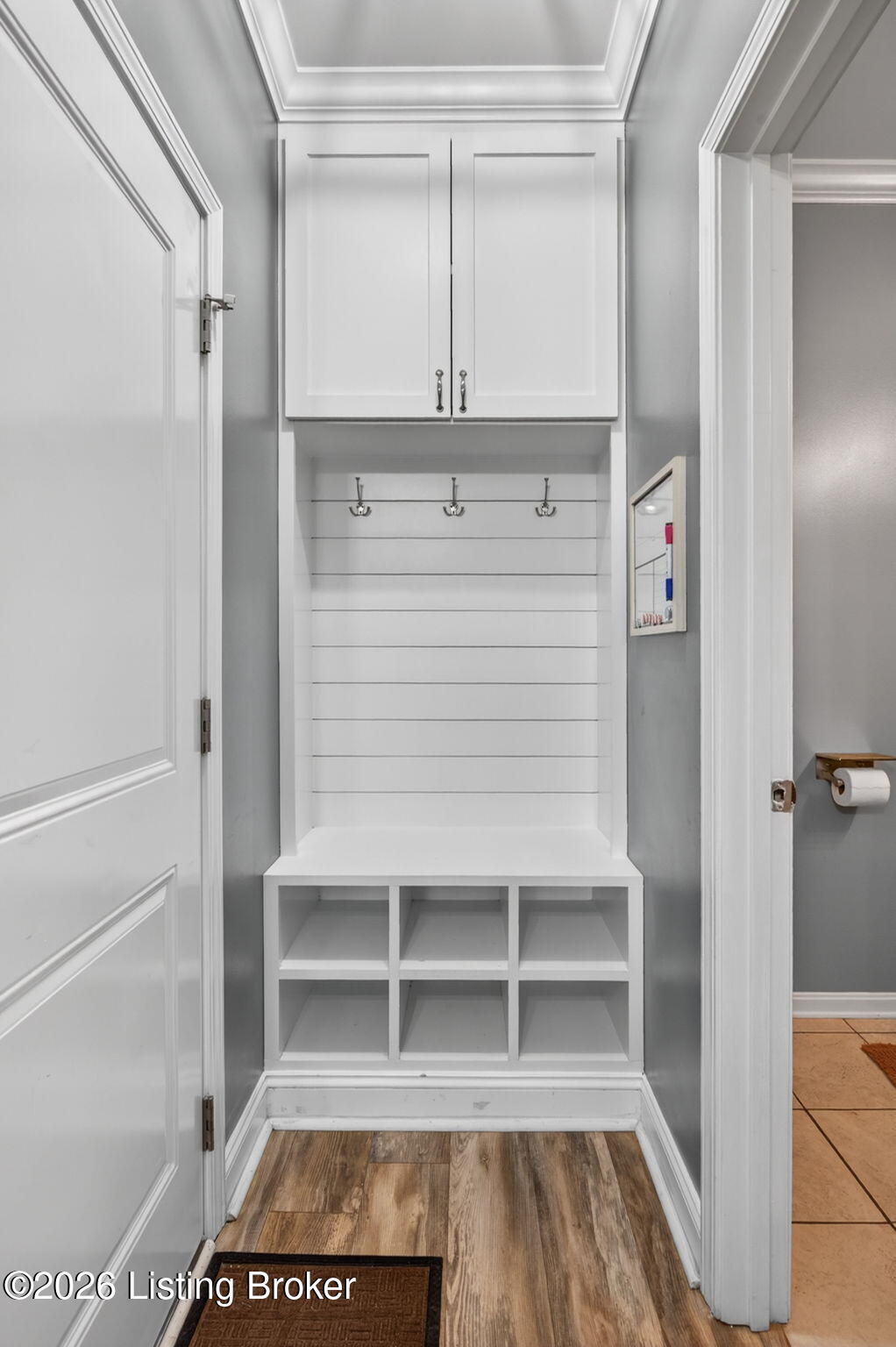 142 Highland Ridge Drive Mount Washington, KY 40047 - Photo 22 of 61 The drop zone showcases a built-in bench seat with open cubby storage below, coat hooks on a shiplap backing, and overhead cabinetry for additional storage