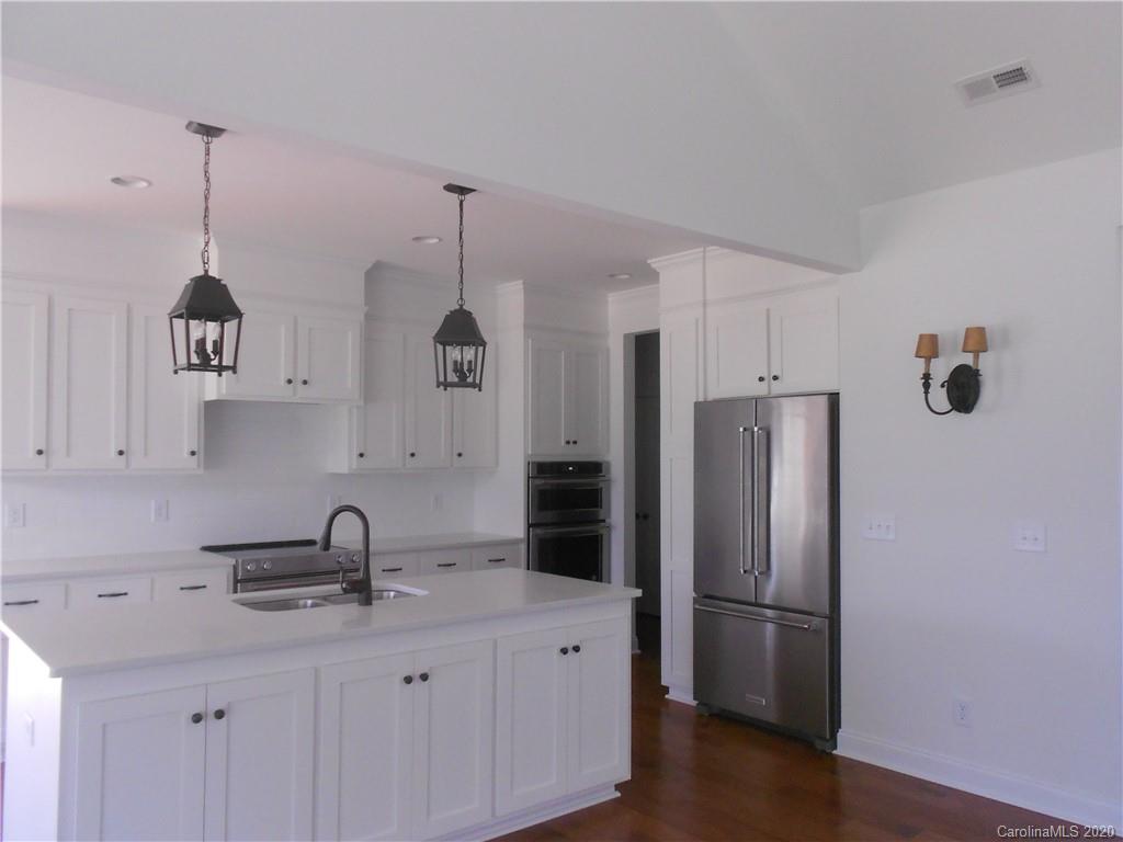 5606 Unionville-Brief Road Monroe, NC 28110 - Photo 11 of 21 a kitchen with stainless steel appliances a sink a refrigerator a center island and cabinets