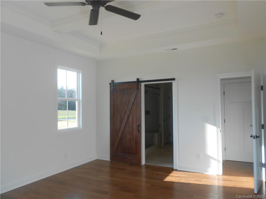 5606 Unionville-Brief Road Monroe, NC 28110 - Photo 14 of 21 a view of an empty room with wooden floor and a window