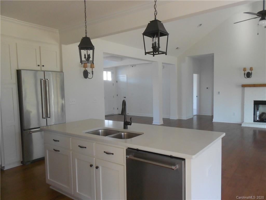 5606 Unionville-Brief Road Monroe, NC 28110 - Photo 6 of 21 a kitchen with stainless steel appliances a sink a refrigerator a center island and cabinets