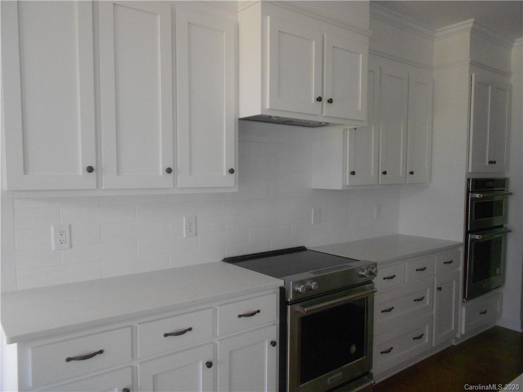 5606 Unionville-Brief Road Monroe, NC 28110 - Photo 7 of 21 a kitchen with granite countertop white cabinets and a stove