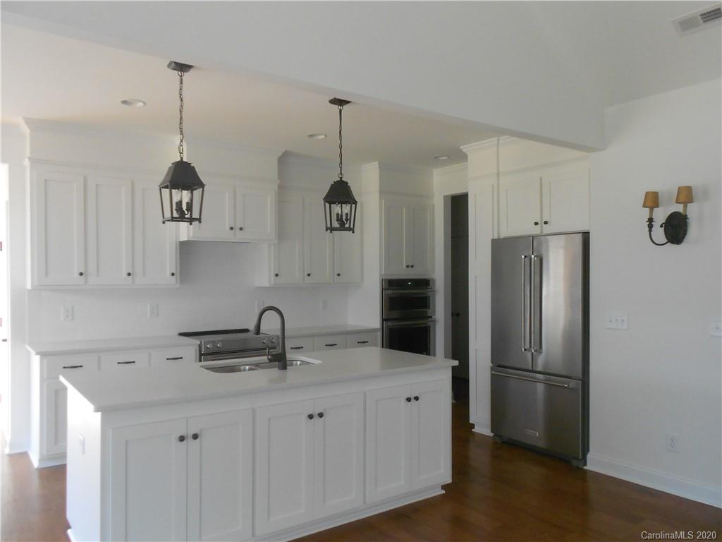 5606 Unionville-Brief Road Monroe, NC 28110 - Photo 10 of 21 a kitchen with stainless steel appliances a refrigerator a sink a stove a microwave and wooden floor