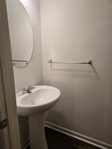 a bathroom with a sink a mirror and a toilet