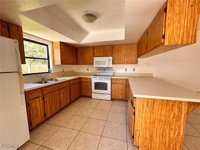 a kitchen with stainless steel appliances granite countertop a sink counter space cabinets and a window