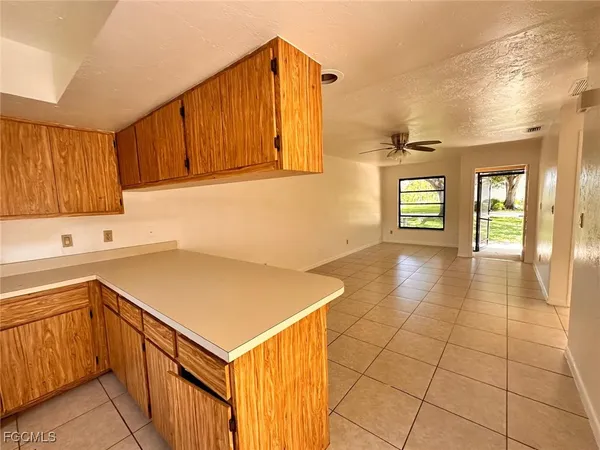 a kitchen with a sink a stove and cabinets