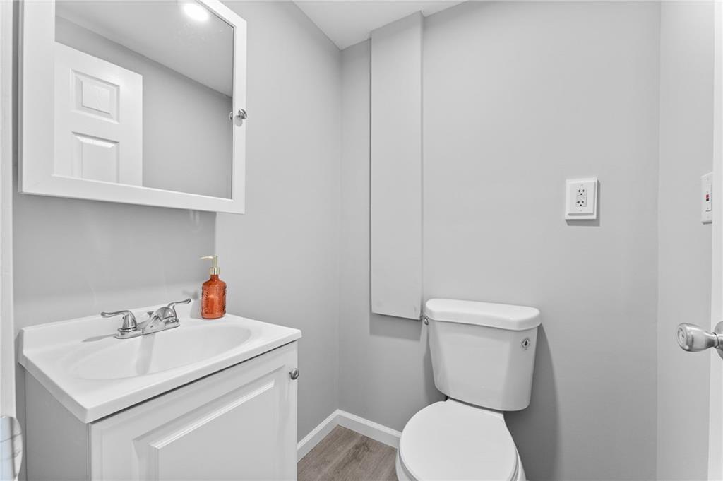 519 Lincoln Street Rochester, PA 15074 - Photo 23 of 32 a bathroom with a toilet sink and mirror