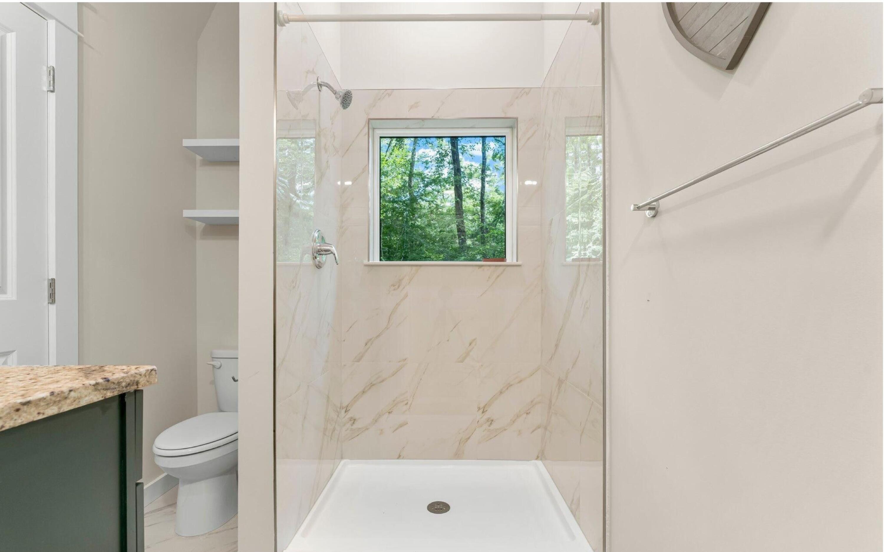 493 Choctawhatchee River Road Ponce de Leon, FL 32455 - Photo 18 of 35 a bathroom with a shower a toilet and a window