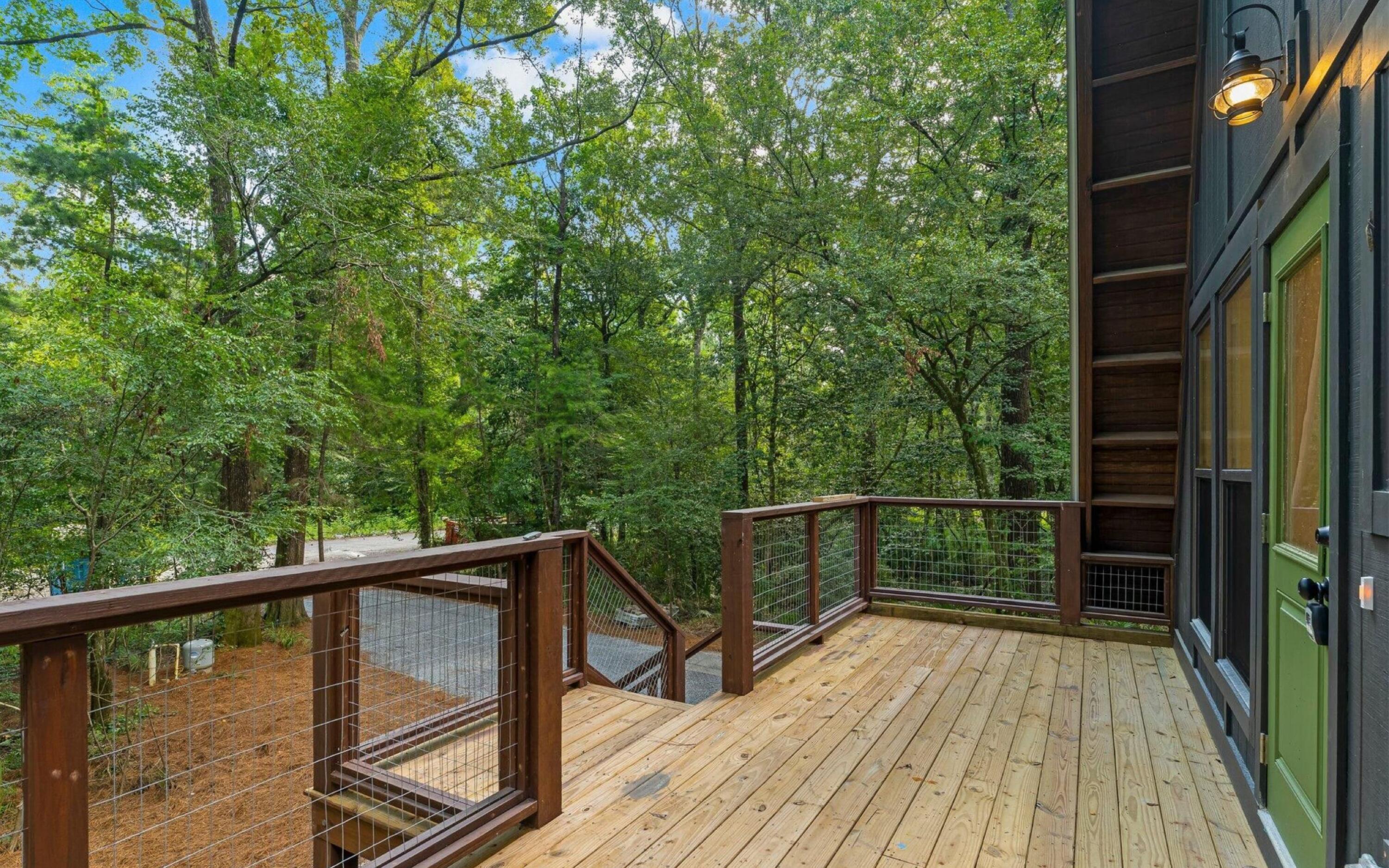 493 Choctawhatchee River Road Ponce de Leon, FL 32455 - Photo 2 of 35 a view of balcony with wooden floor and potted plants