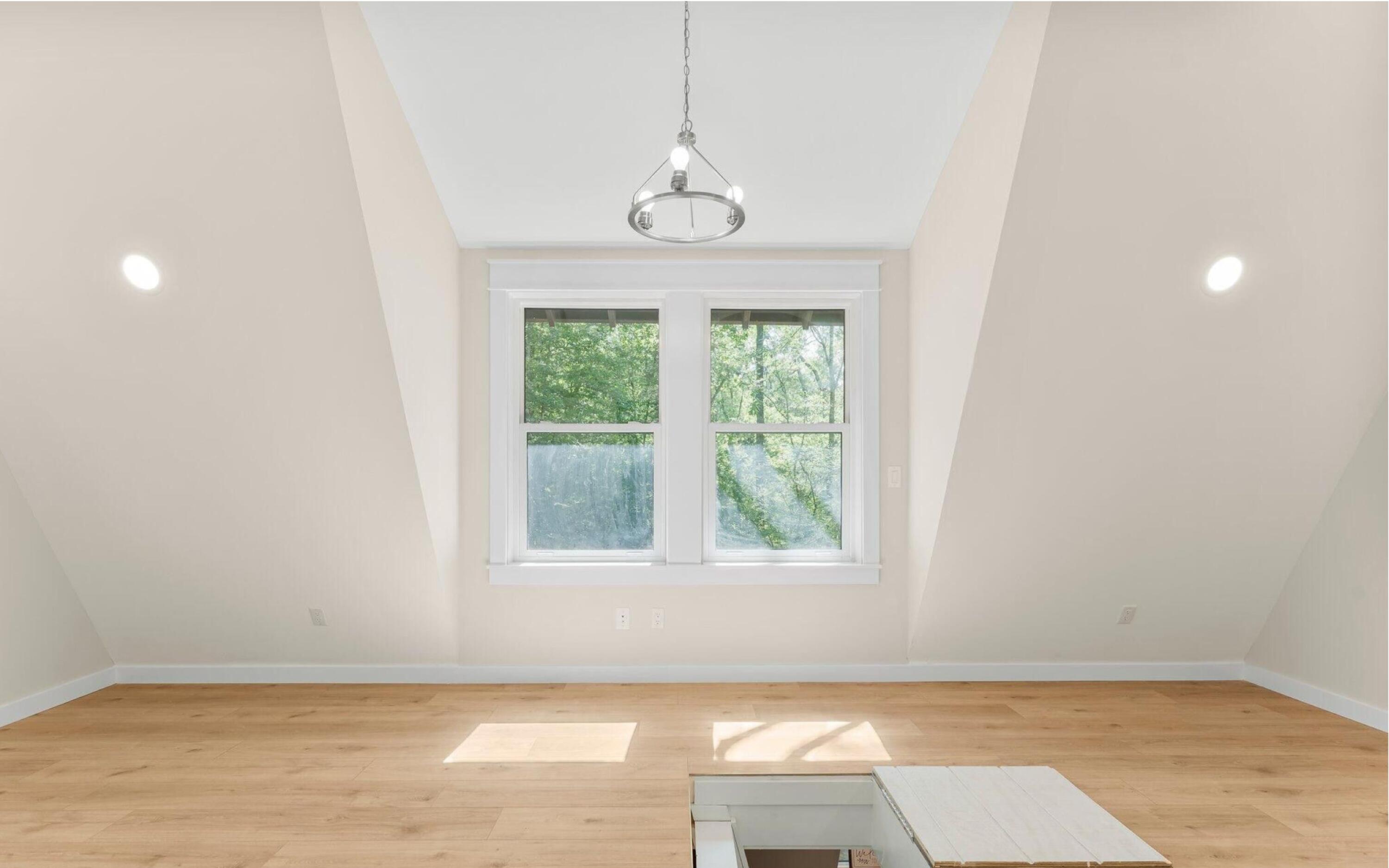 493 Choctawhatchee River Road Ponce de Leon, FL 32455 - Photo 23 of 35 an empty room with wooden floor exposed radiator and a window