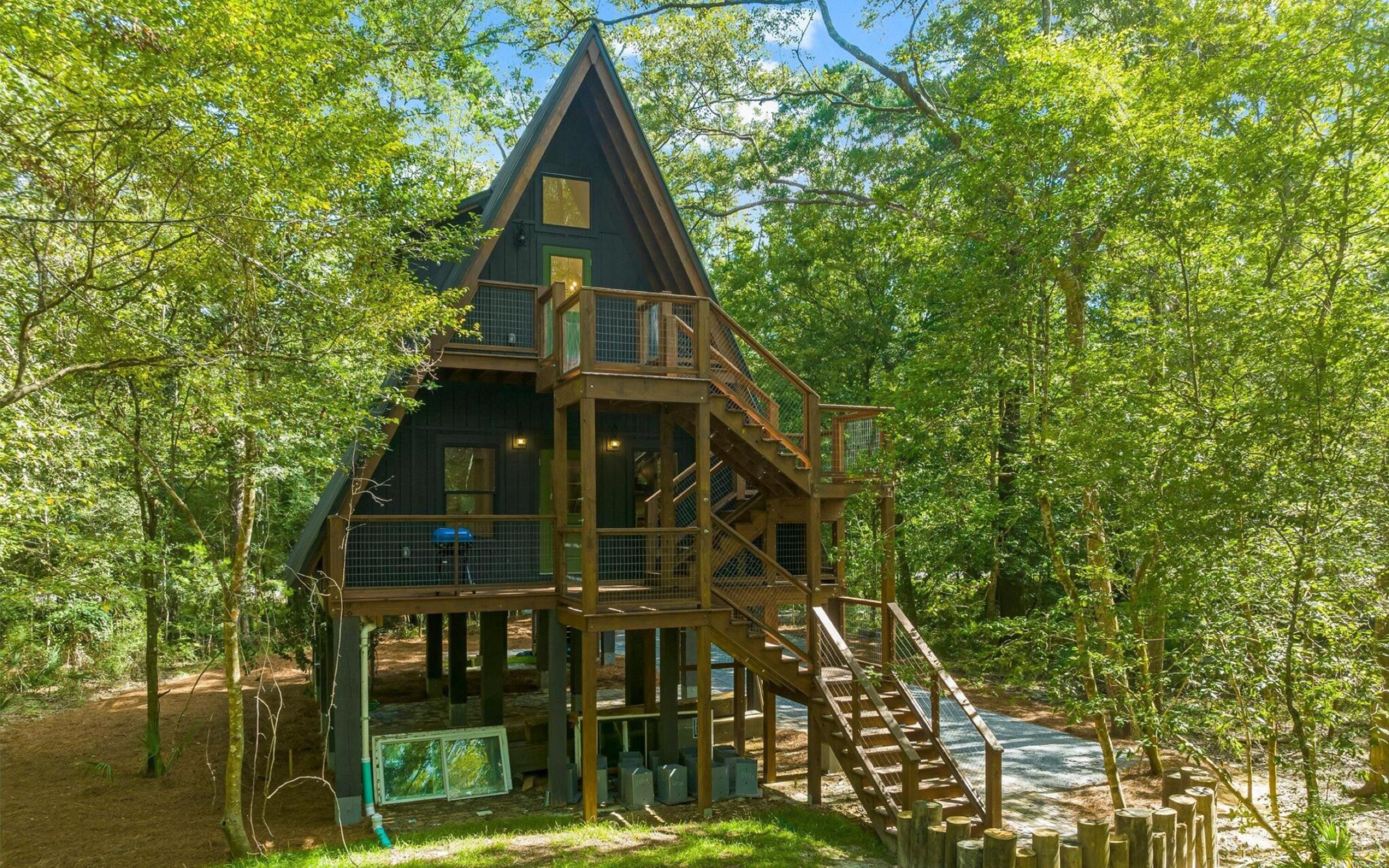 493 Choctawhatchee River Road Ponce de Leon, FL 32455 - Photo 24 of 35 a view of a large building with large tree