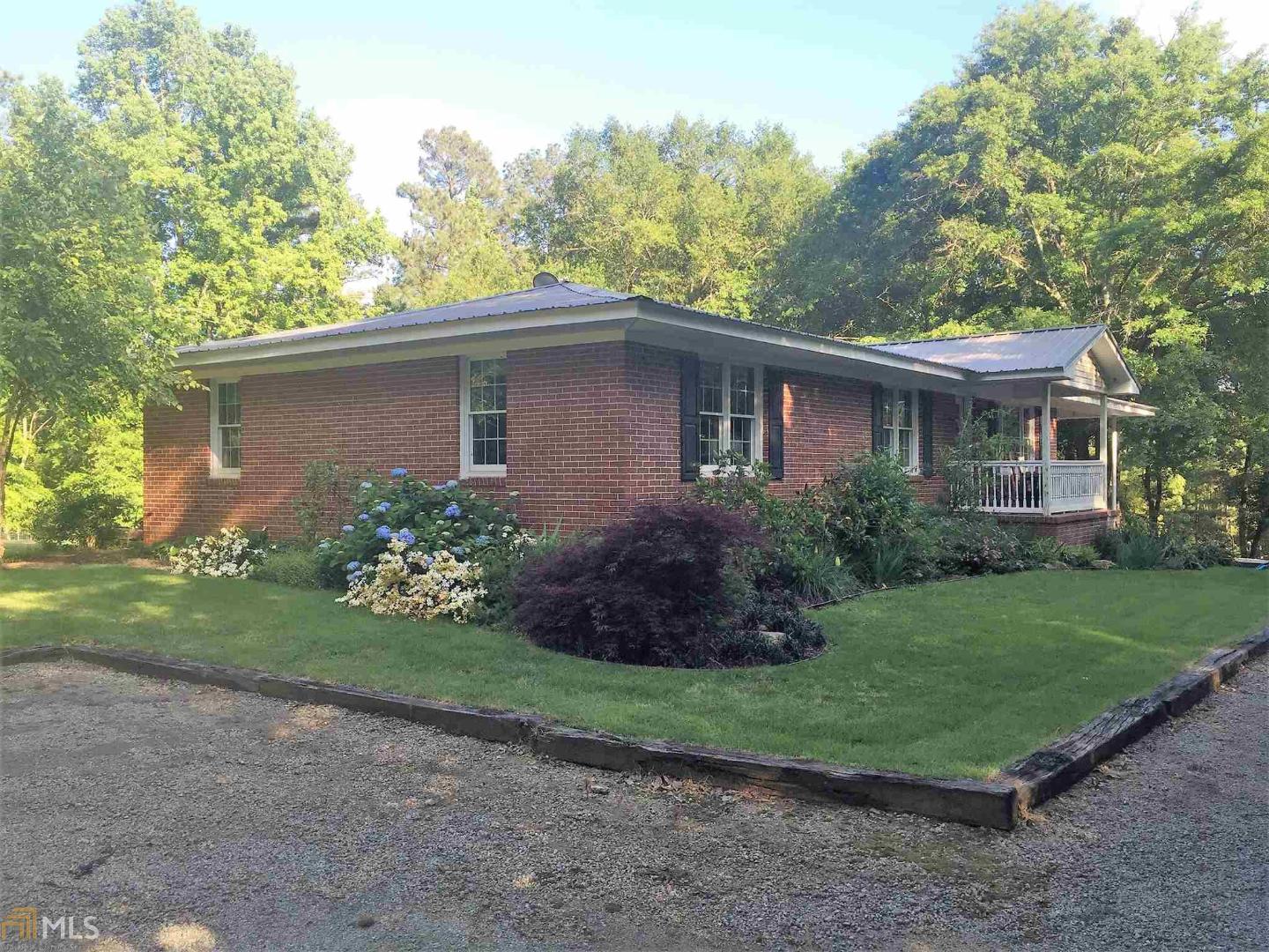 a view of a house with a yard and a garden
