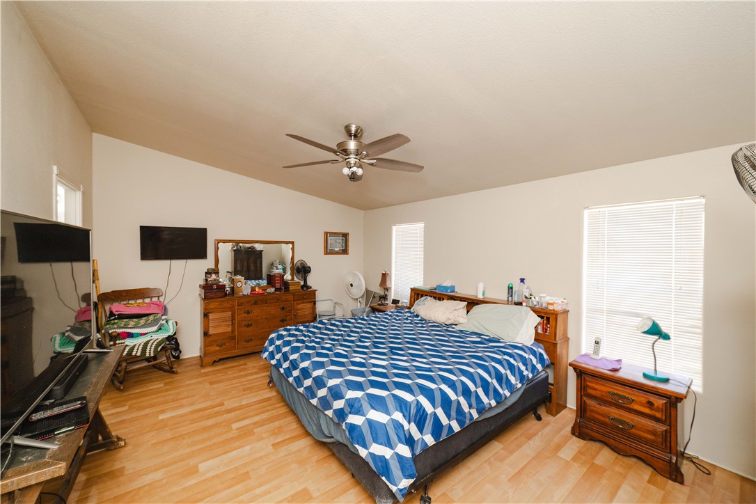 4729 Stewart Mountain Road Golden Valley, AZ 86413 - Photo 11 of 28 a bedroom with a bed and a flat screen tv