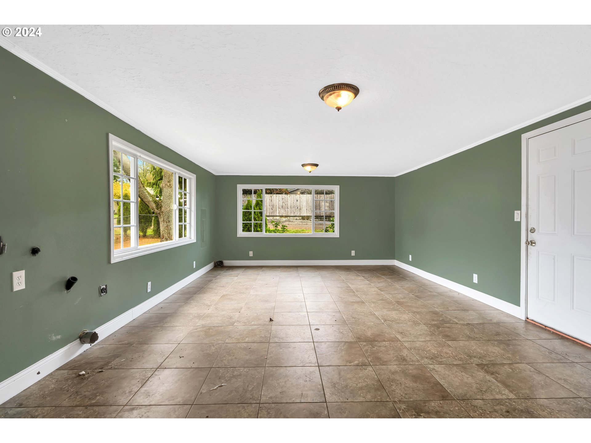 822 Olson Road Longview, WA 98632 - Photo 11 of 27 a view of an empty room with a window and hardwood