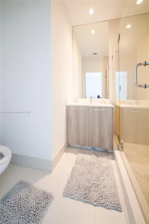 a bathroom with a granite countertop sink a toilet and bathtub