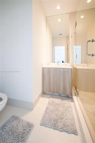 a bathroom with a granite countertop sink a toilet and bathtub