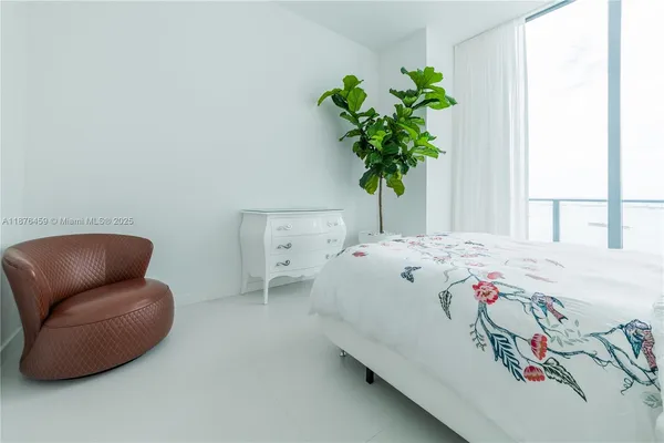 a bedroom with a bed and a potted plant