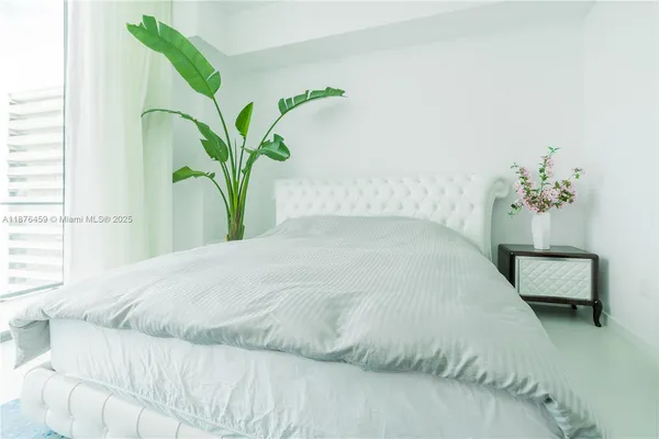 a bedroom with a bed dresser and a window