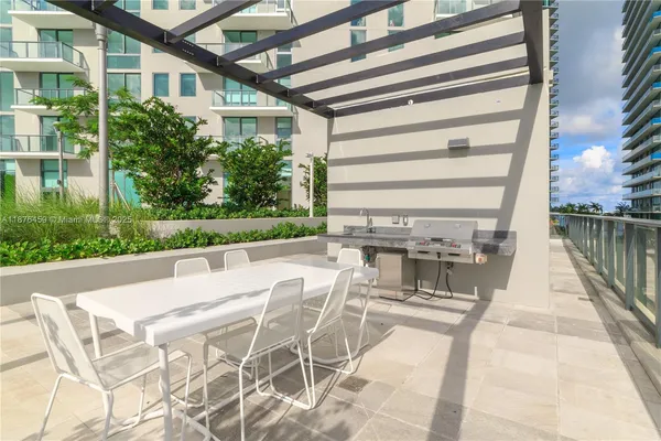 a swimming pool with outdoor seating and yard