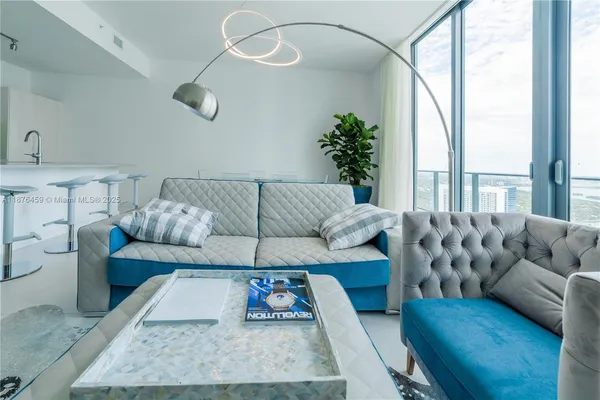 a living room with furniture and a large window