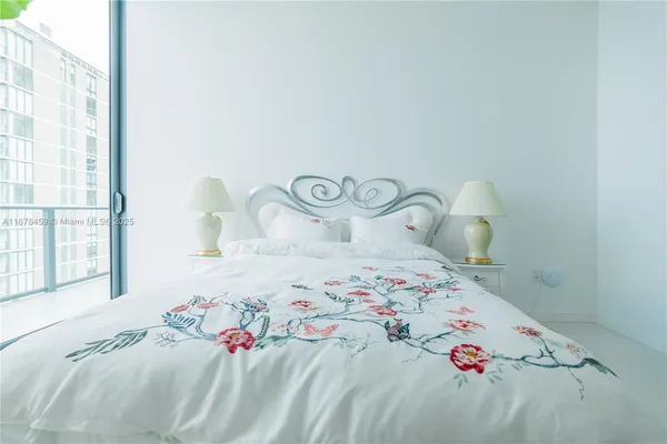 a bedroom with a bed and a window