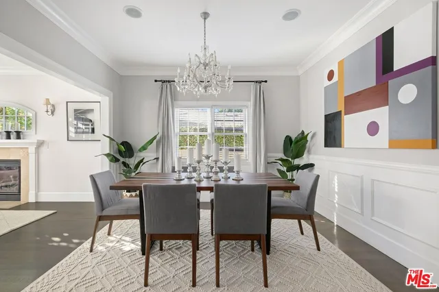 a view of a dining room with furniture and chandelier