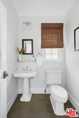 a bathroom with a toilet a sink and a window