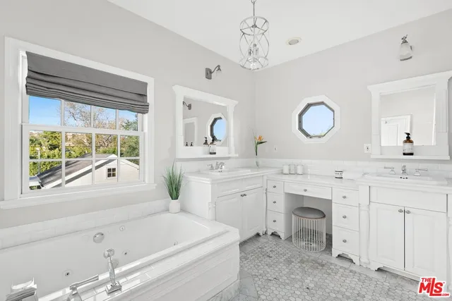 a bathroom with a granite countertop sink mirror and a bathtub