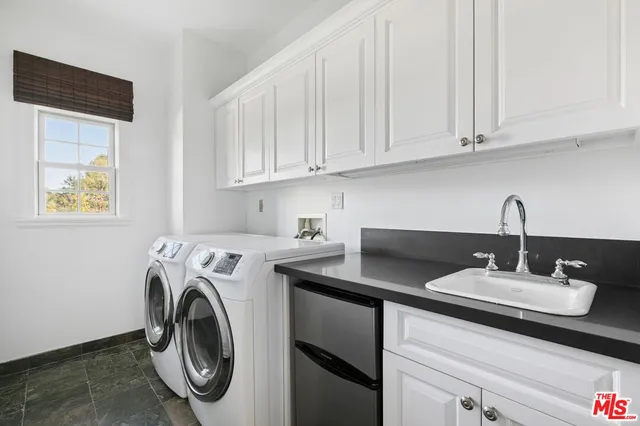 a kitchen with stainless steel appliances white cabinets and a sink