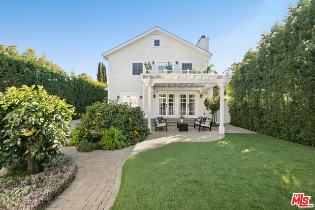 a view of house with a yard and porch