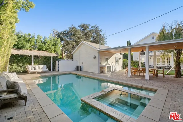 a view of a patio with swimming pool table and chairs