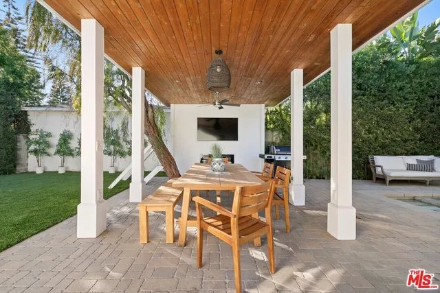 a view of an outdoor dining space with furniture and garden