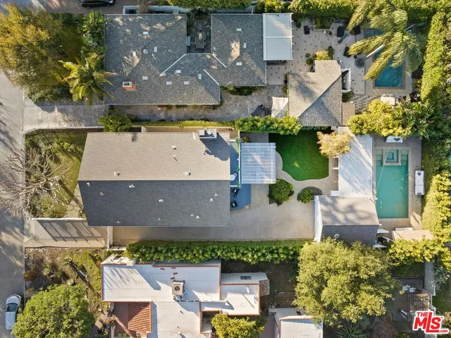 an aerial view of a house with a yard and garden