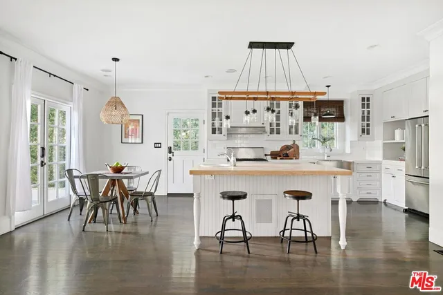 a dining table with chairs and wooden floor