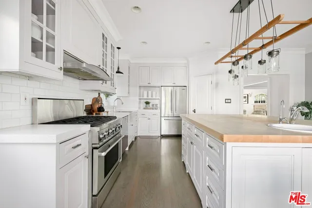 a kitchen with stainless steel appliances granite countertop lots of counter top space and wooden floor