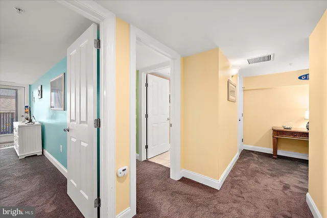 a living room with furniture a flat screen tv and a floor to ceiling window