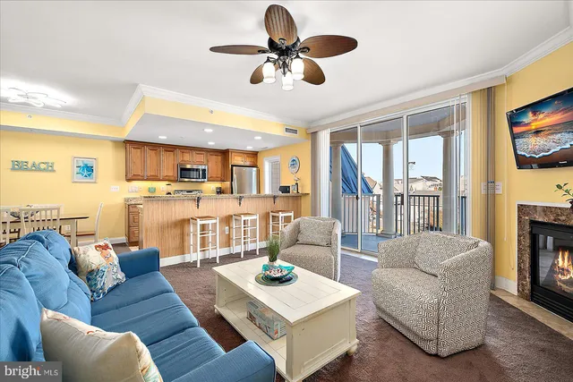 a living room with furniture a fireplace and a flat screen tv