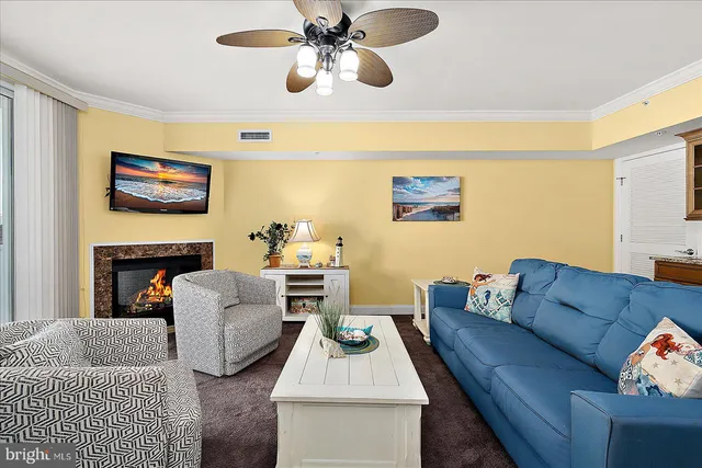 a living room with furniture kitchen view and a chandelier